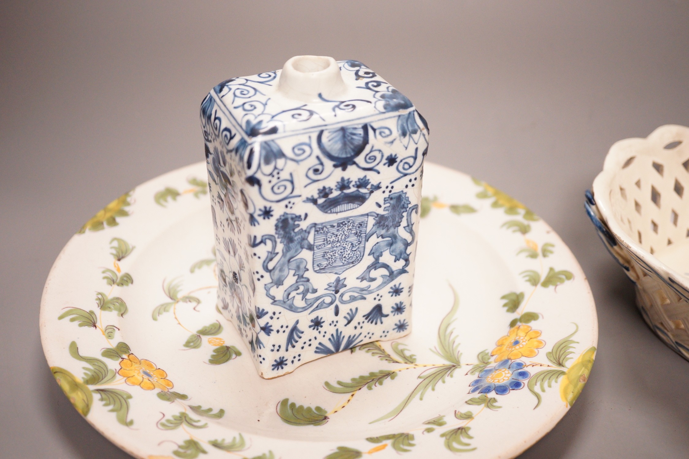 A Leeds creamware jar, a Delft armorial caddy, a Cantagalli maiolica plate and a creamware chestnut basket
